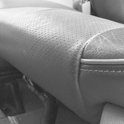 Cover with perforation extending past the seam